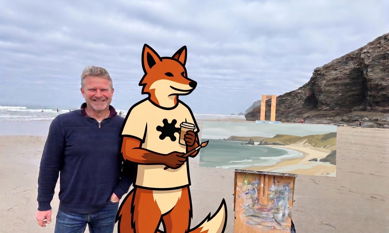 Damian on a Cornish beach beside his easel, with InkFox the fox holding a coffee and a paintbrush